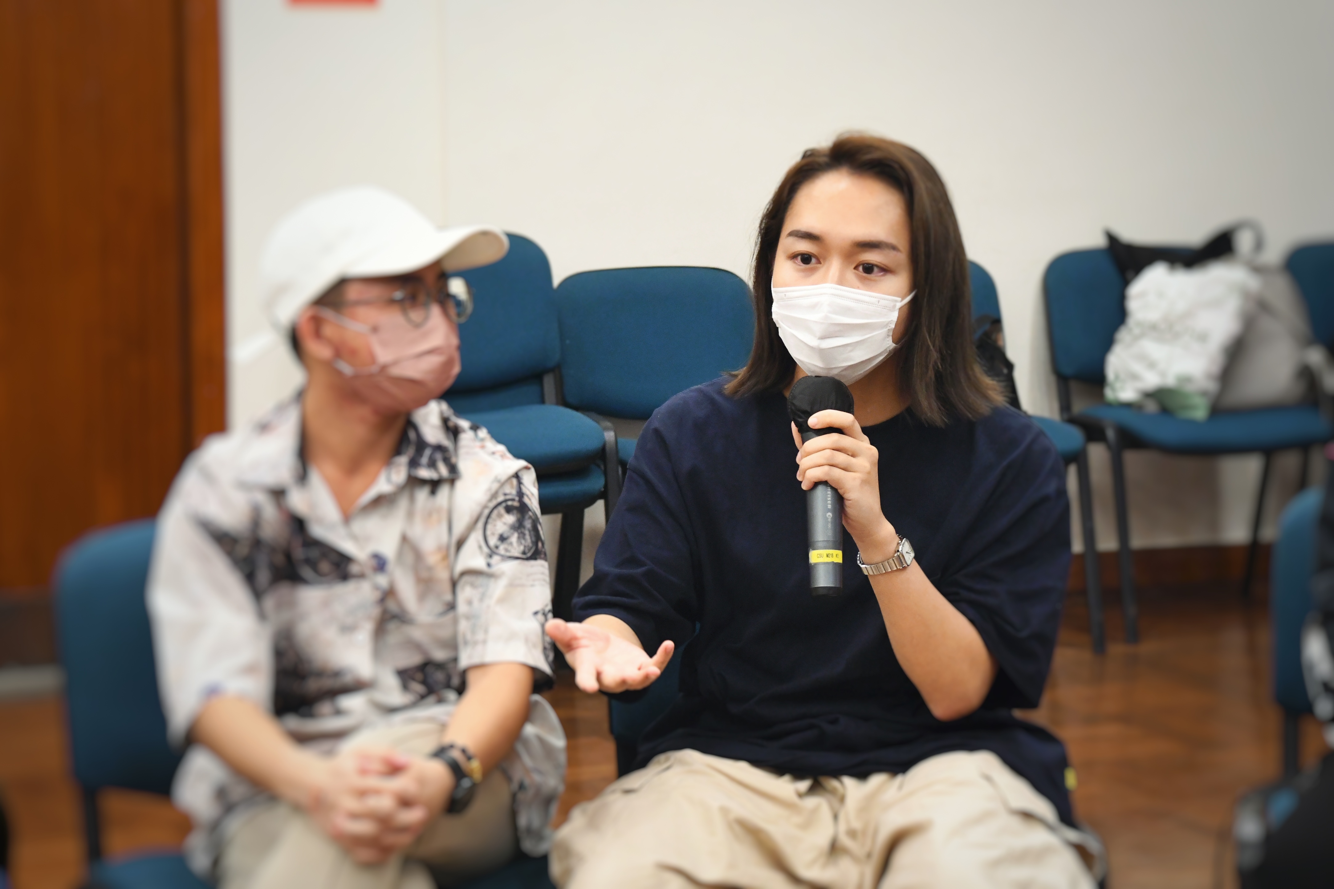 Event Poster: Guest speakers holding a mic to speak